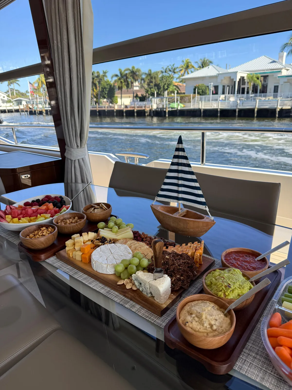 The charcuterie board and the dips laid out on the aft table while the boat is under way