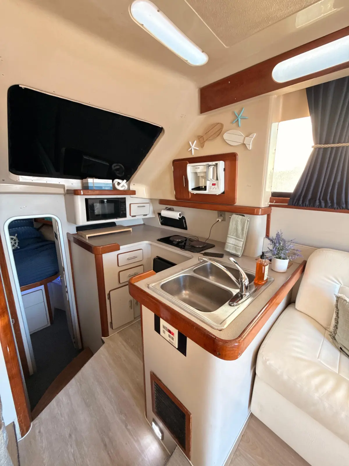 The galley on the Luhrs, with sink, microwave and the door to the forward berth