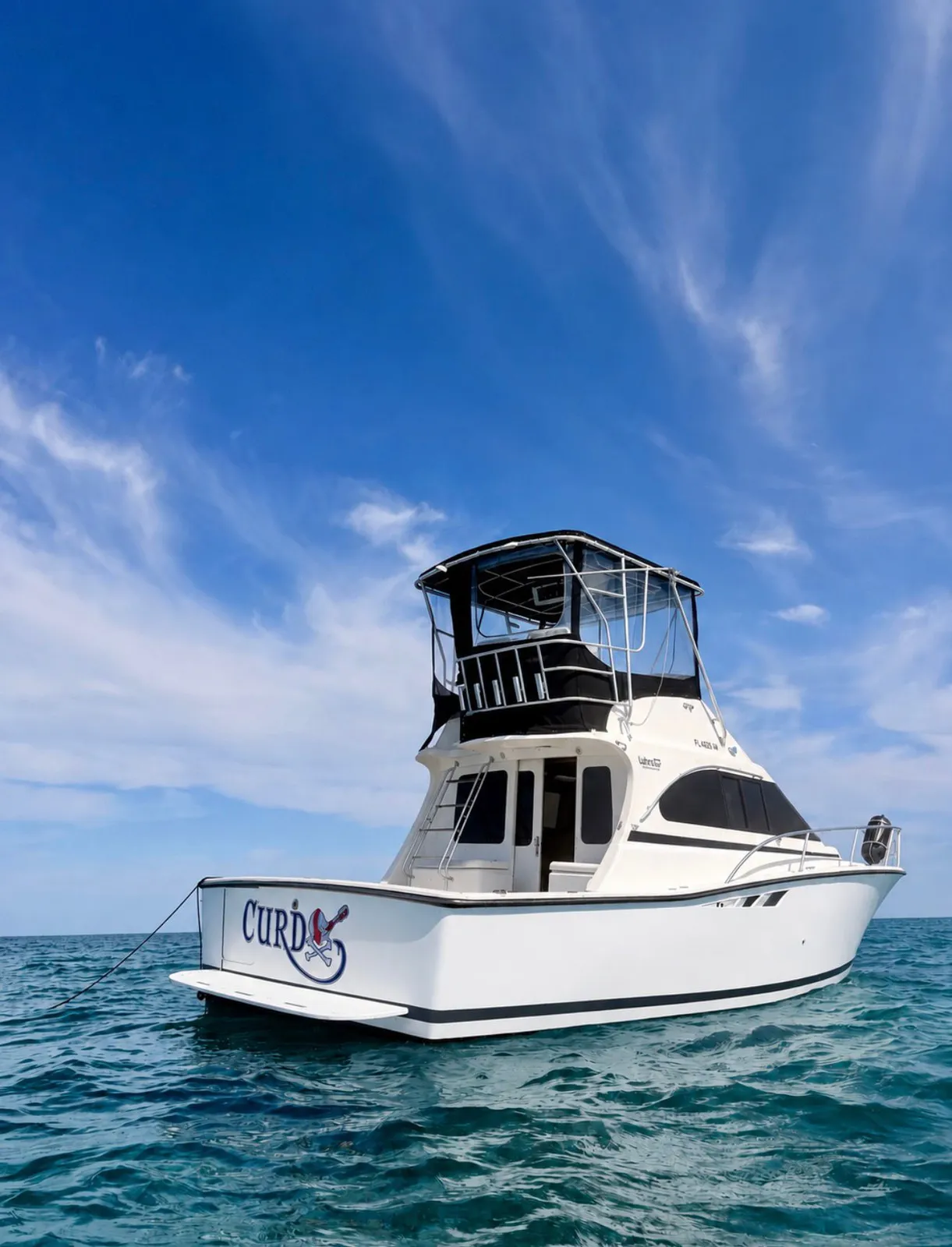 The Luhrs seen from astern, anchored in open water