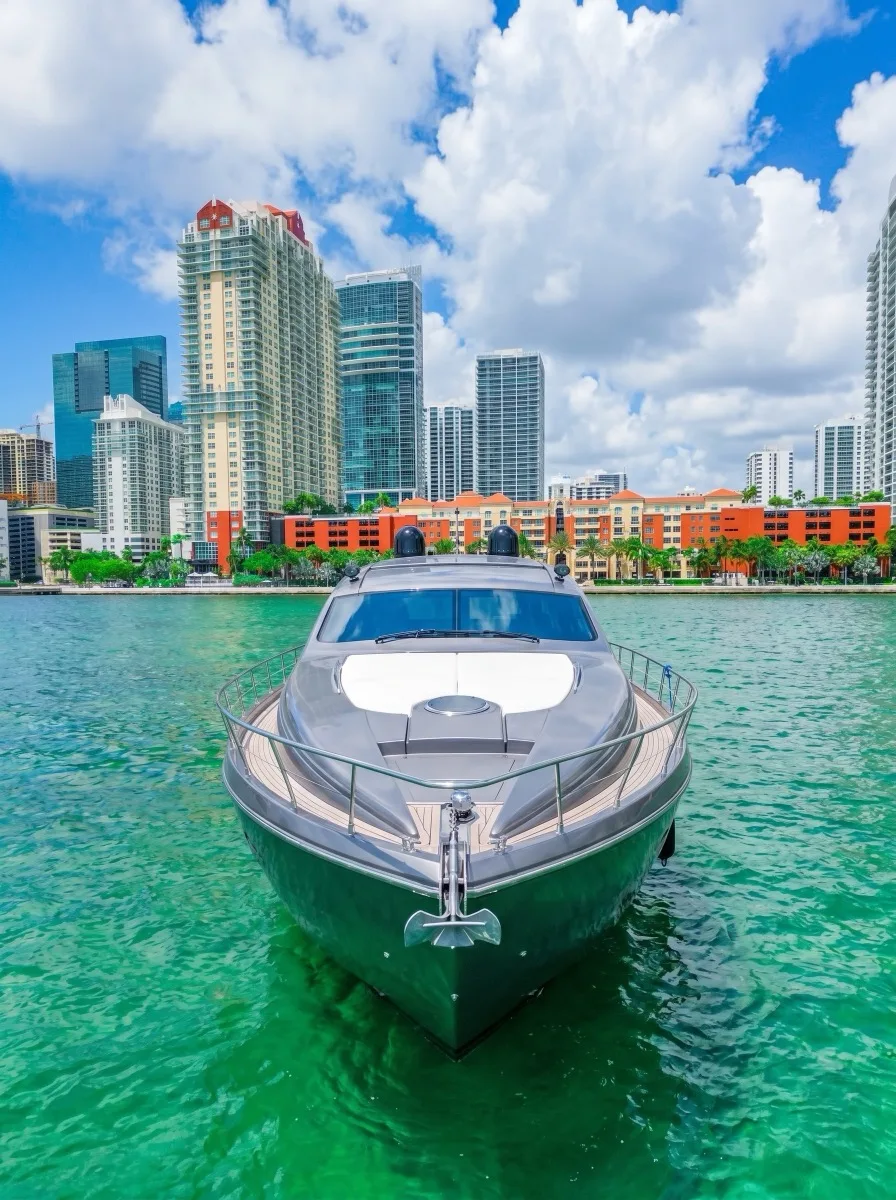 The bow of the Pershing 64 over green water